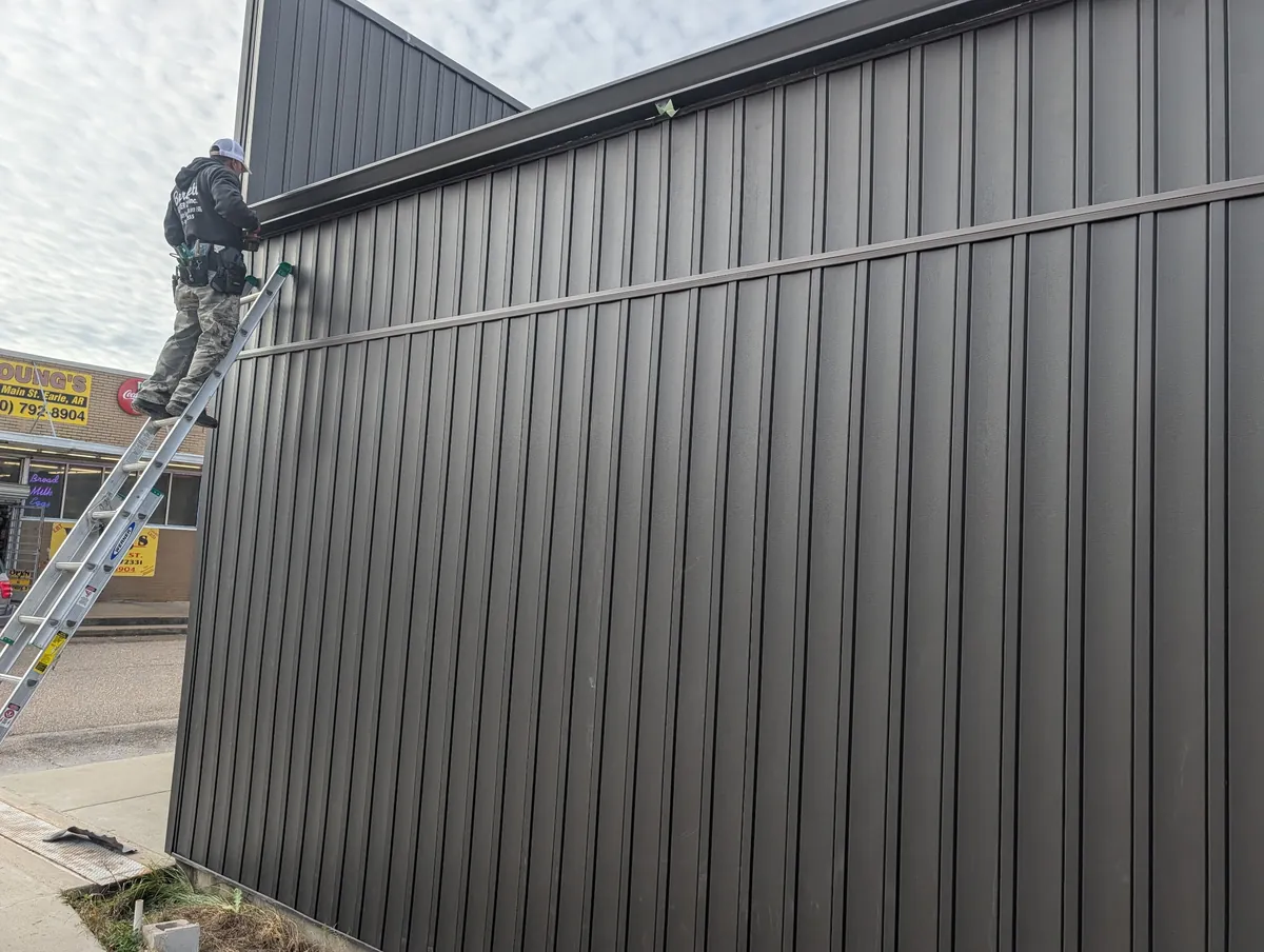 After: the finished metal panel siding