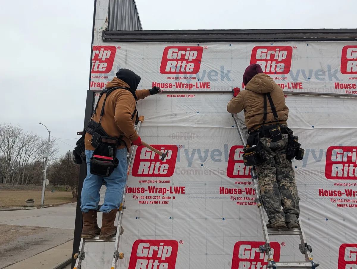 Before: house wrap going up on the bare wall